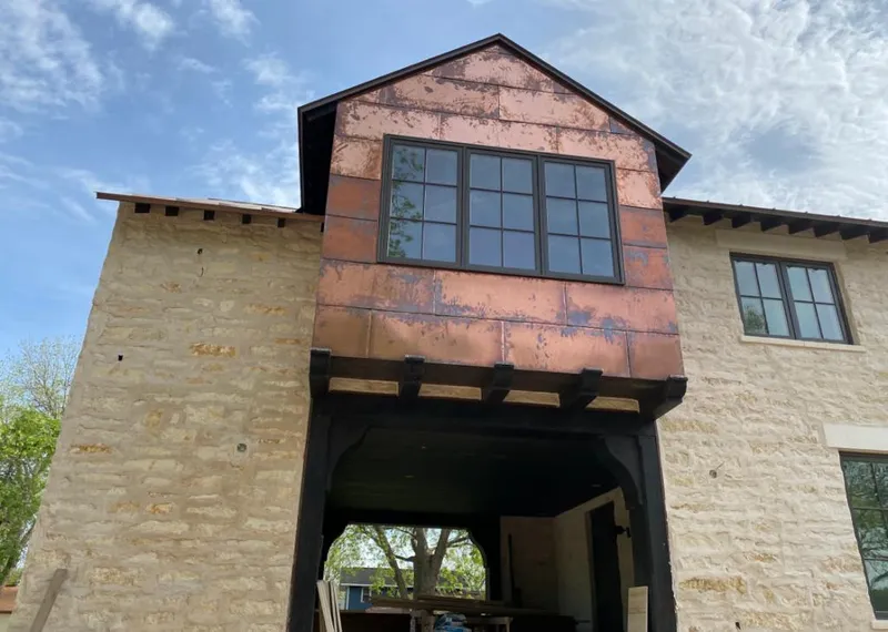 Copper metal panel facade on a stone building for Skylight Installation in Ridgefield
